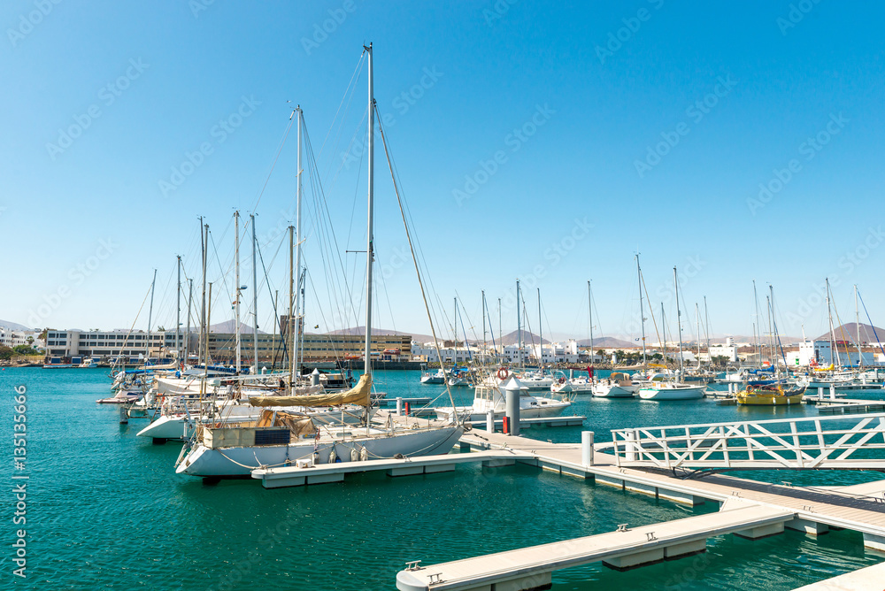 Few yachts in the habror, city background, Spain