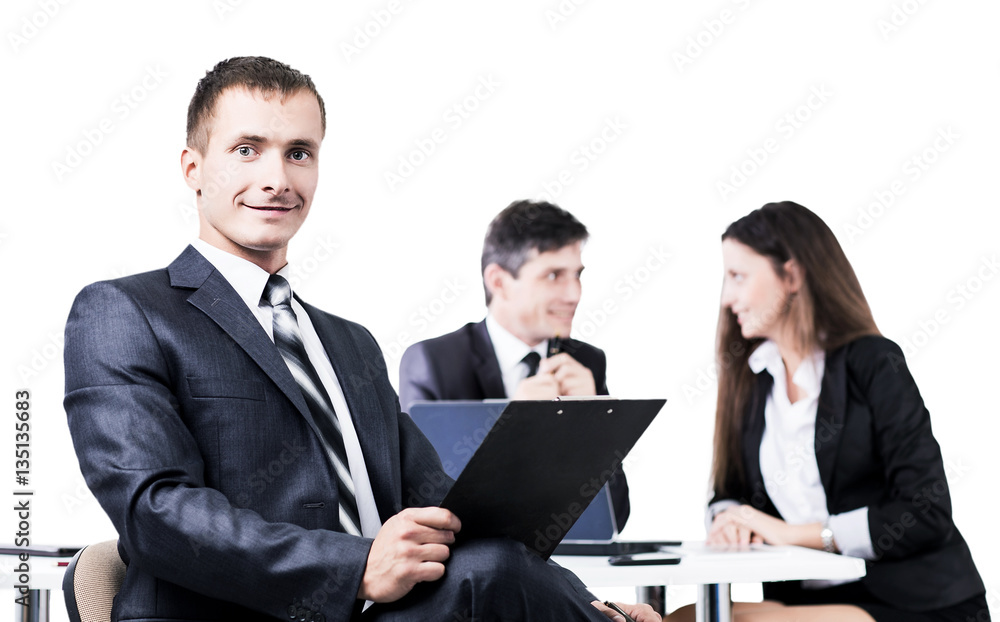 Portrait of a young businessman on background working team Portrait of a young businessman on background working team