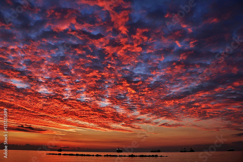 Romantic sky at sunset or sunrise over the calm sea