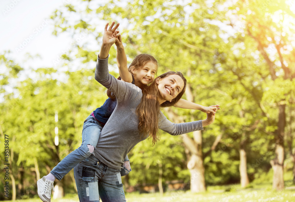 Fototapeta premium happy mother with her daughter in the park on a sunny day