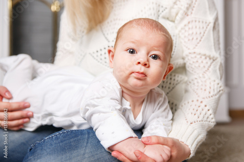 small child on the mother's hands. positive human emotions, look in the frame