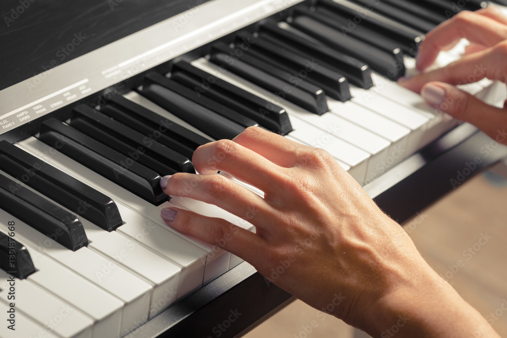 Closeup of hands playing piano. Music and hobby concept Closeup of hands playing piano. Music and hobby concept