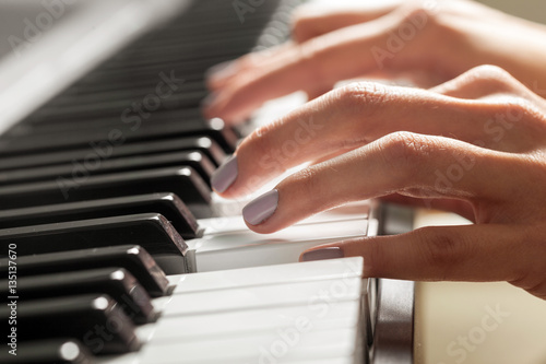 Closeup of hands playing piano. Music and hobby concept