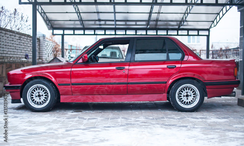 Restored red old car, which looks like new. Side view