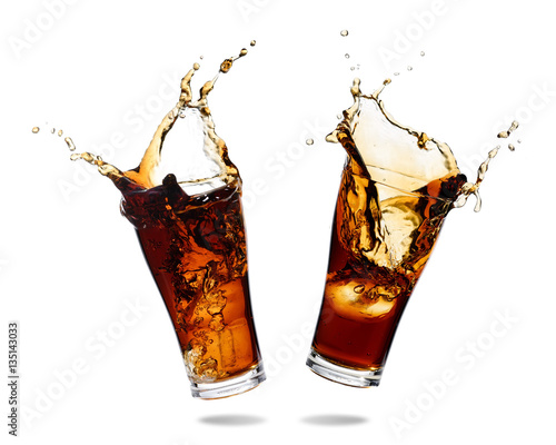 Couple cola splashing out of a glass., Isolated white background.