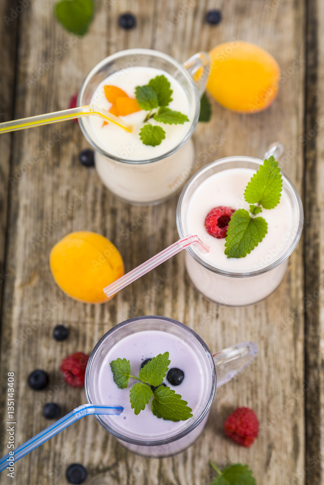 Milkshakes with raspberries, blueberries, apricots and mint lea Milkshakes with raspberries, blueberries, apricots and mint lea