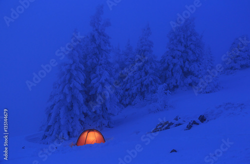 Red tent in the snow of the Vercors mountains in France.
