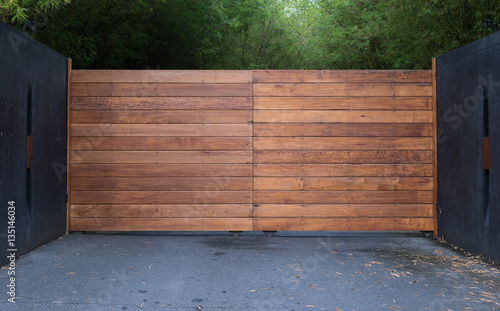 Sliding driveway door with iron and wooden panel