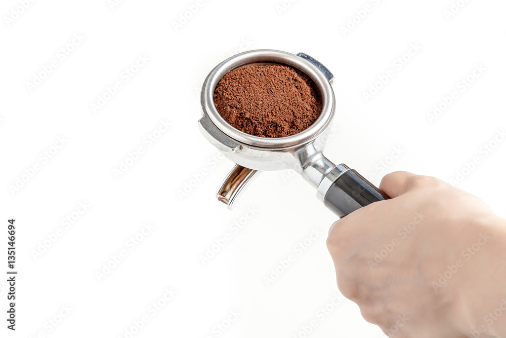 Barista hold the portafilter with coffee ground, prepare to tamp and brew espresso shot