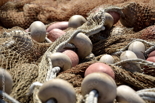 fishing nets deposited on the dock to dry