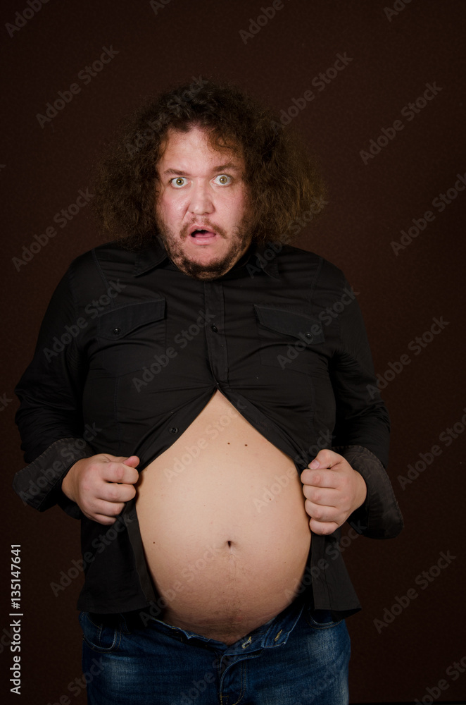 Funny pregnant man. Guy with a big belly. Stock Photo | Adobe Stock