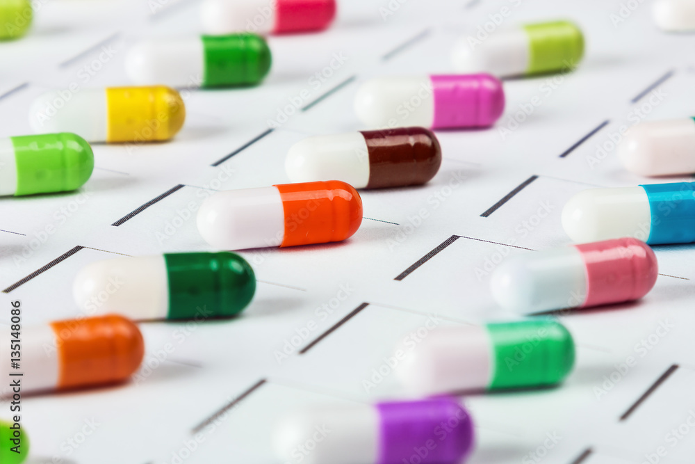 pills are of different color on the calendar. Schedule medication. Focus on a light green pill