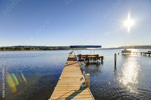 Photography Private dock with jet ski lifts and covered boat lift, Lake Washington
