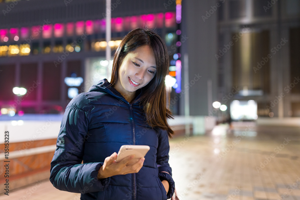 Fototapeta premium Woman sending sms on cellphone