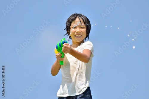 水鉄砲で遊ぶ女の子(青空) © hanapon1002