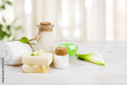 Composition of spa wellness products on light wooden background