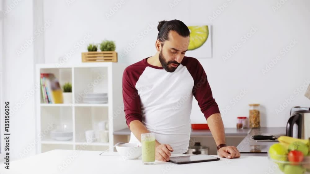 man with tablet pc eating breakfast at home man with tablet pc eating breakfast at home
