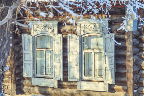 The windows of the old wooden house in the winter