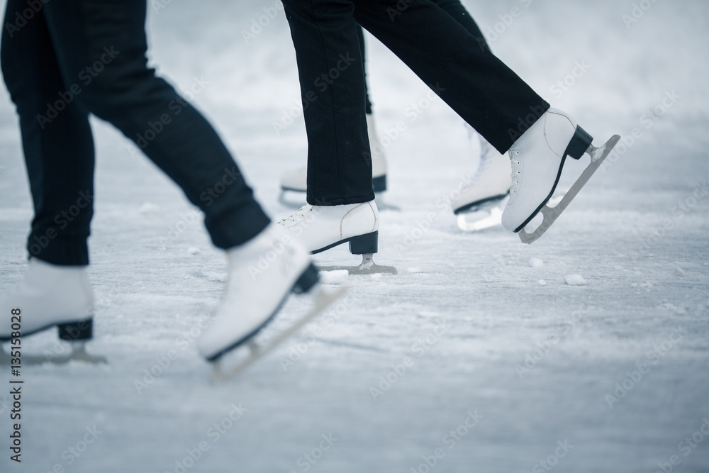 Young woman ice skating outdoors on a pond on a freezing winter Young woman ice skating outdoors on a pond on a freezing winter