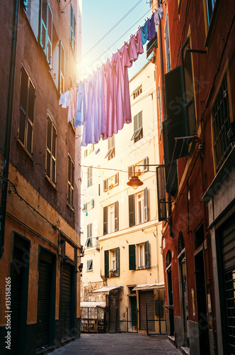 Colorful linen drying between houses in old italian street