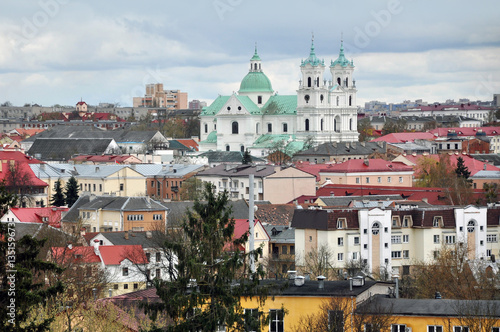 Panoramic view of Grodno, Belarus. The historic city center with red tile roofs and the old Catholic church in the Baroque style during the day.