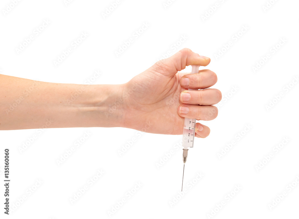 Female hand holding syringe. Isolated on white. Female hand holding syringe. Isolated on white.
