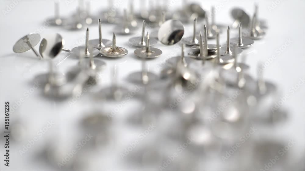 Rack focus on shiny metal push pins Stock Video Adobe Stock