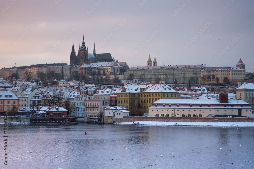 Fototapeta premium View of Prague castle and buildings under the snow from Charles Bridge