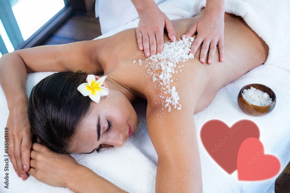 Composite image of salt scrub massage with love hearts Composite image of salt scrub massage with love hearts
