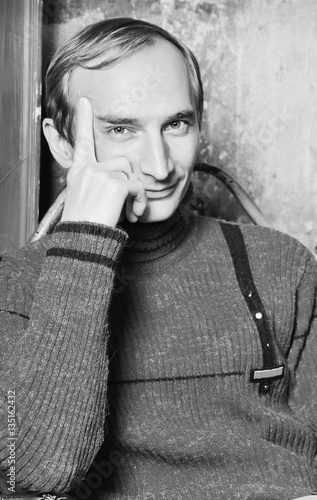  balding man wearing fashionable red sweater sitting  on the met photo