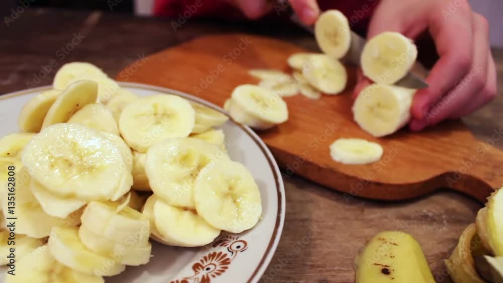 Slicing a banana into thin slices Slicing a banana into thin slices