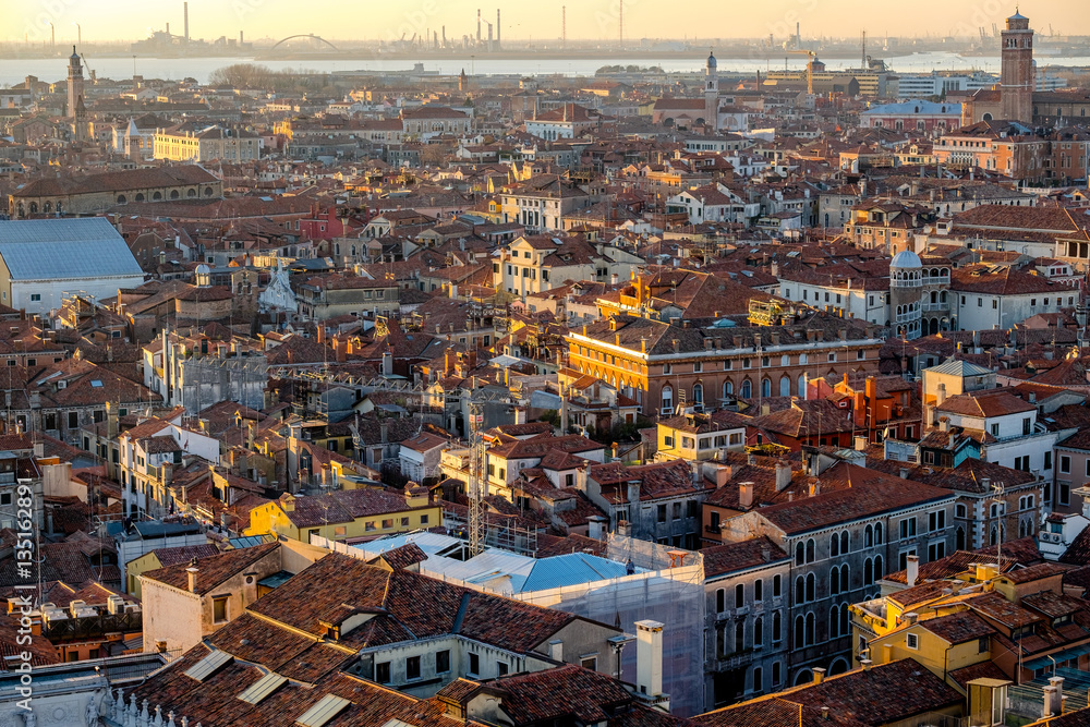 Panoramic aerial cityscape of Venice,with rooftops, the sea at sunset, Veneto, Italy.