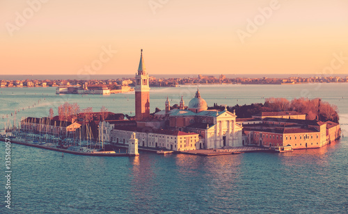 Panoramic aerial cityscape of Venice,with rooftops, the sea at sunset, Veneto, Italy. © Augustin Lazaroiu