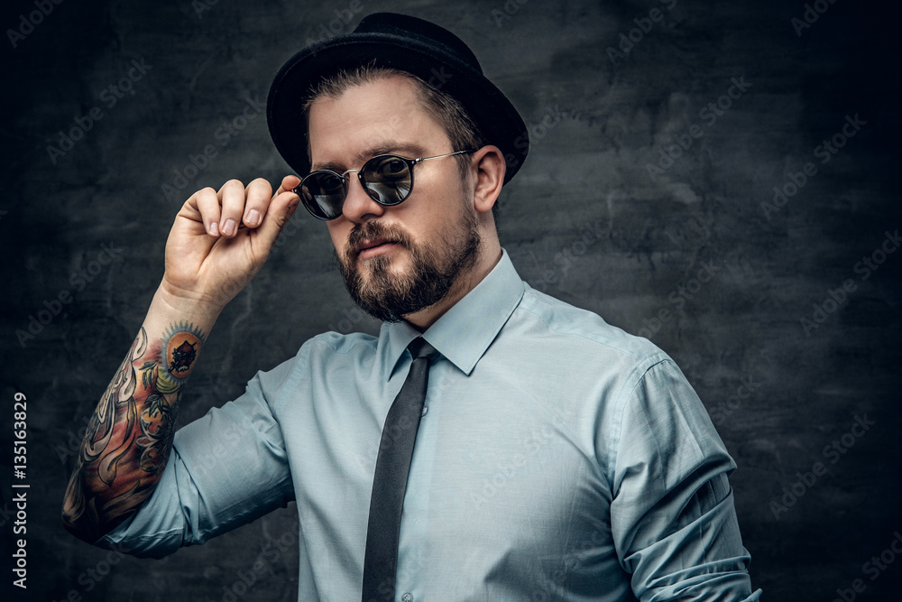 Bearded man with tattooed arms. Bearded man with tattooed arms.