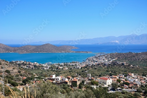 Elevated view of Elounda with views across the sea towards the island of Spinalonga, Elounda, Crete.