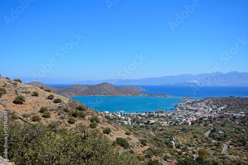 Fototapeta Naklejka Na Ścianę i Meble -  Elevated view of Elounda with views across the sea towards the island of Spinalonga, Elounda, Crete.