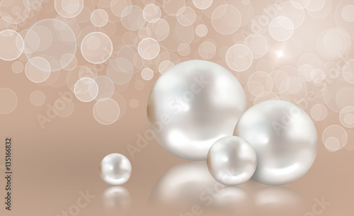 Four white pearls on peach shimmering light background