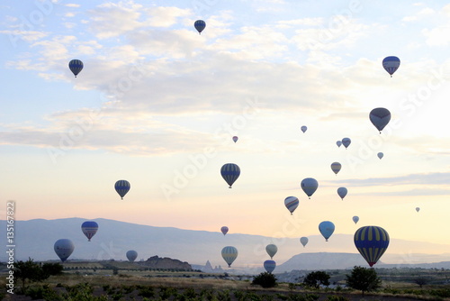 Travel to Goreme, Cappadocia, Turkey. The sunrise in the mountains with a lot of air hot balloons in the sky.