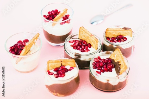 Six glass bowl with sweet dessert with chocolate and vanilla mousse.