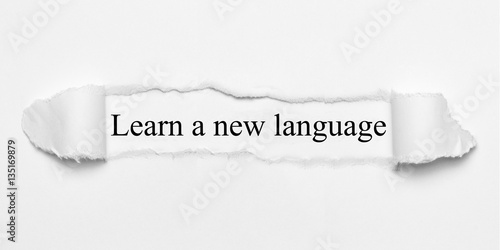 Obraz na płótnie Learn a new language on white torn paper