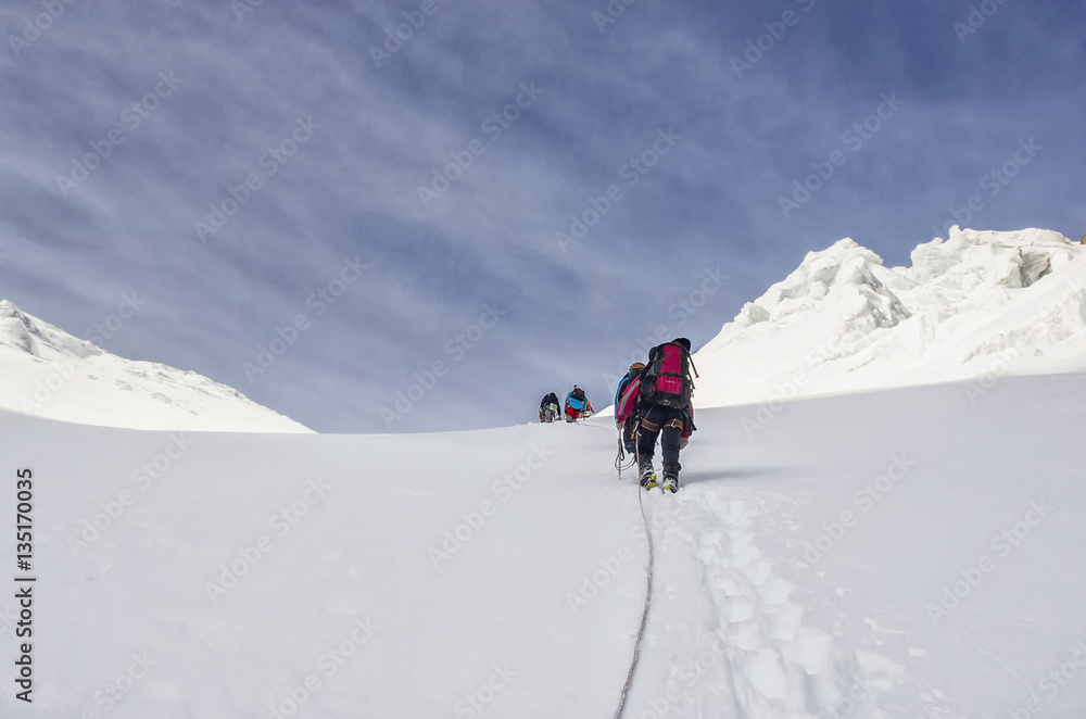 Group of climbers goes to the hill climbing in the mountains