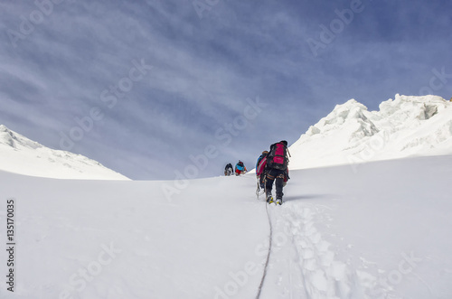Group of climbers goes to the hill climbing in the mountains