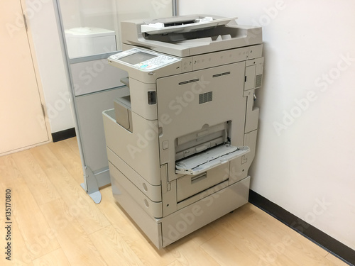 Photocopier / copy machine, printer and fax for office paper work with office background