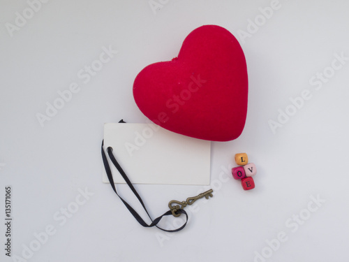 Red heart with key and word LOVE on white background