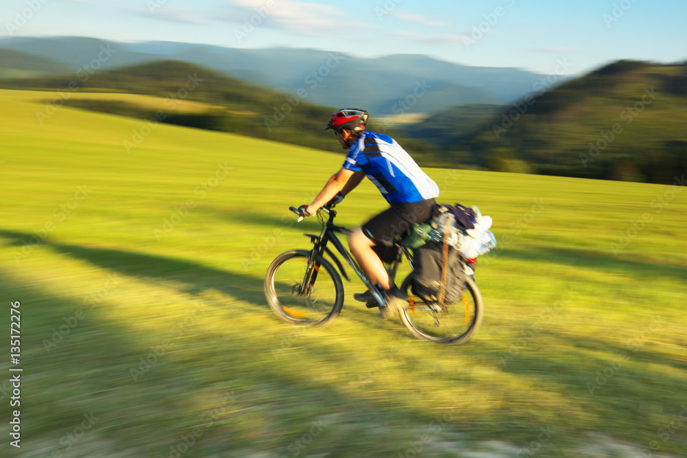 Tourist on bicycle with mountain on background, Slovakia, pannin