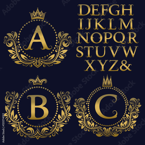 Vintage monogram kit. Golden letters and floral coat of arms frames for creating initial logo in antique style.