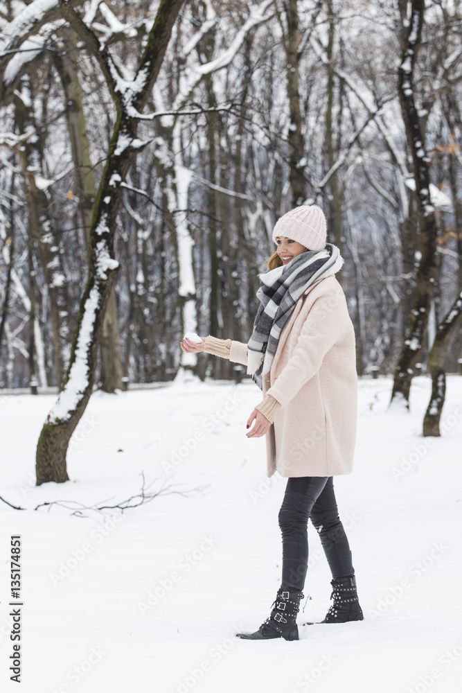 Snowball fight. A woman throwing a snowball Snowball fight. A woman throwing a snowball