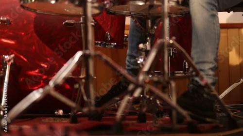 Drummer on stage playing kick drum photo