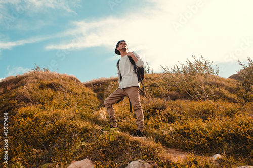 Young man hiking with backpack