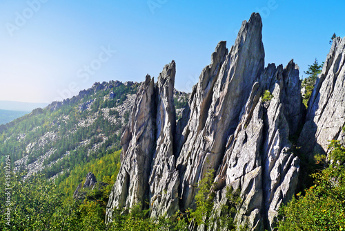 Sharp as the spikes of rock in a picturesque valley National Park. National Park Taganay, Chelyabinsk oblast, Russia. photo